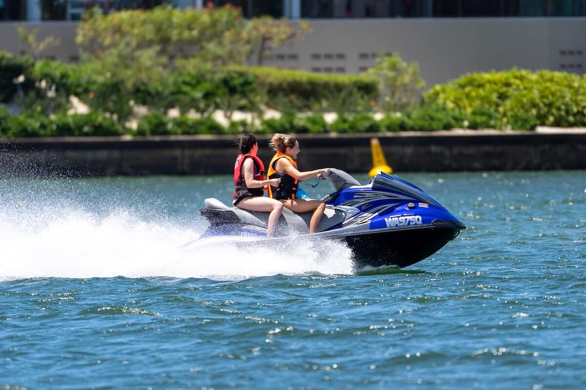 two people riding a jet ski in water